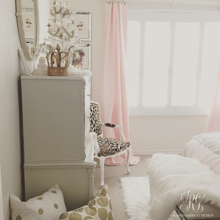 Pink and gold girls room with leopard and white fur, table top feather wreath