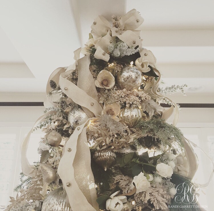 Elegant flocked christmas tree with mercury glass ornaments, magnolias, and jingle bells ribbon