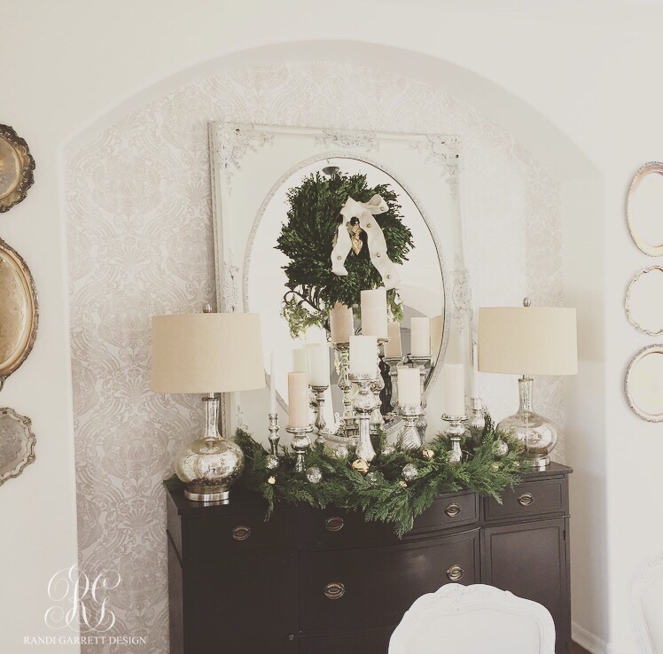 Elegant Christmas dining room using fresh boxwood and faux garland and mercury glass candles 