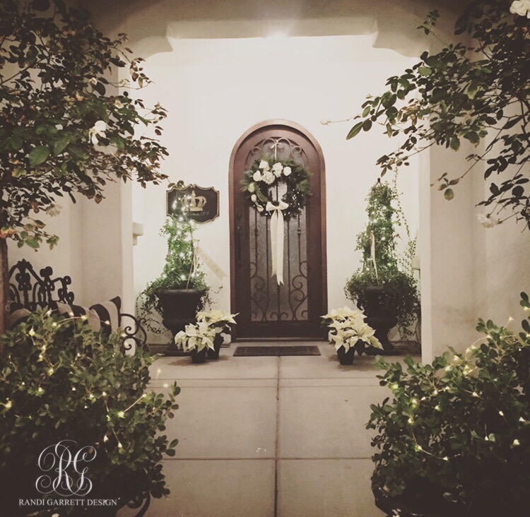 Christmas Porch with white poinsettias and boxwood