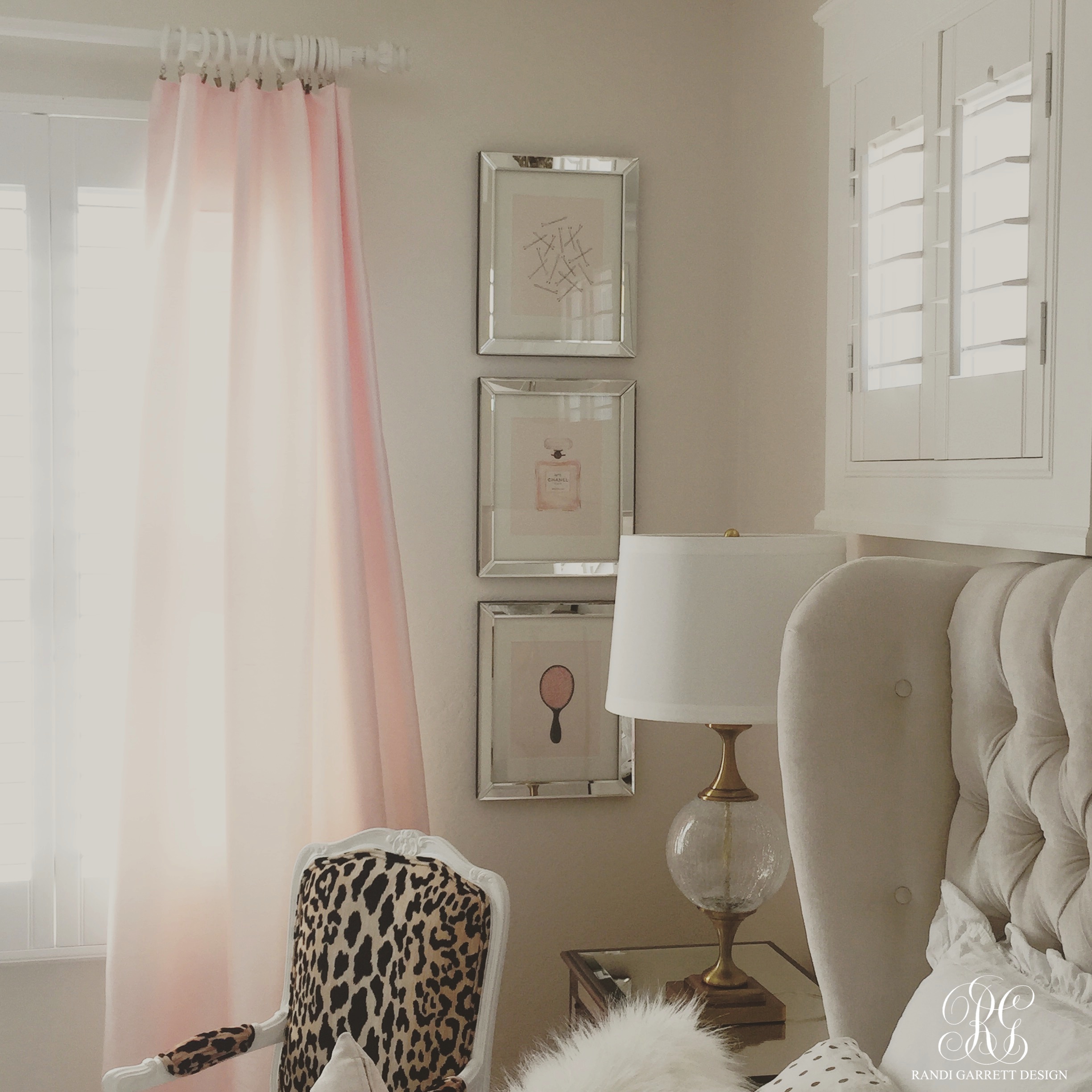 Pink and gold bedroom by Randi Garrett Design with mirror framed frames