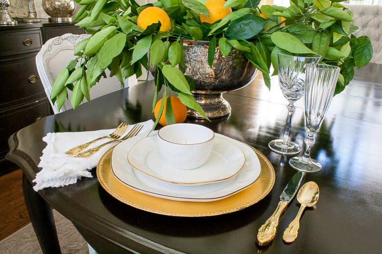 Elegant place setting with fresh oranges featuring Skyros Designs Cantaria dishes