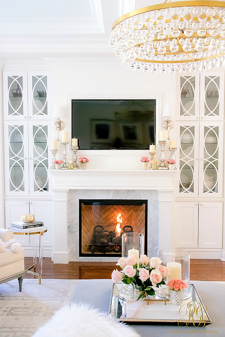 white fireplace with bookcases