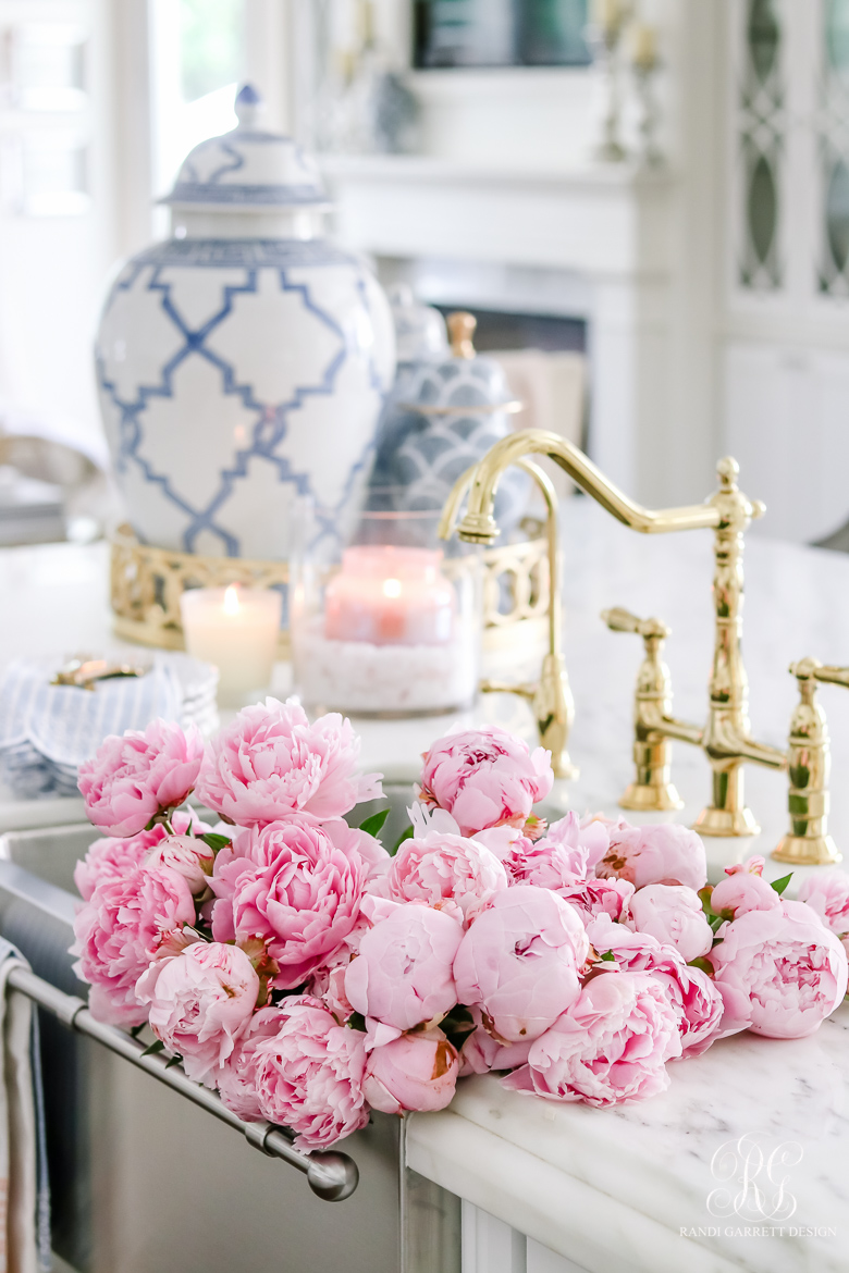 elegant kitchen with pink peonies in the sink