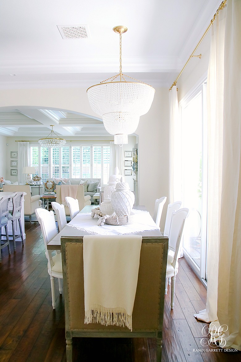 Kitchen table styled for summer - white ginger jars - beaded chandelier 