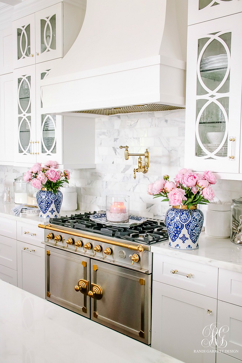 white kitchen with pink peonies