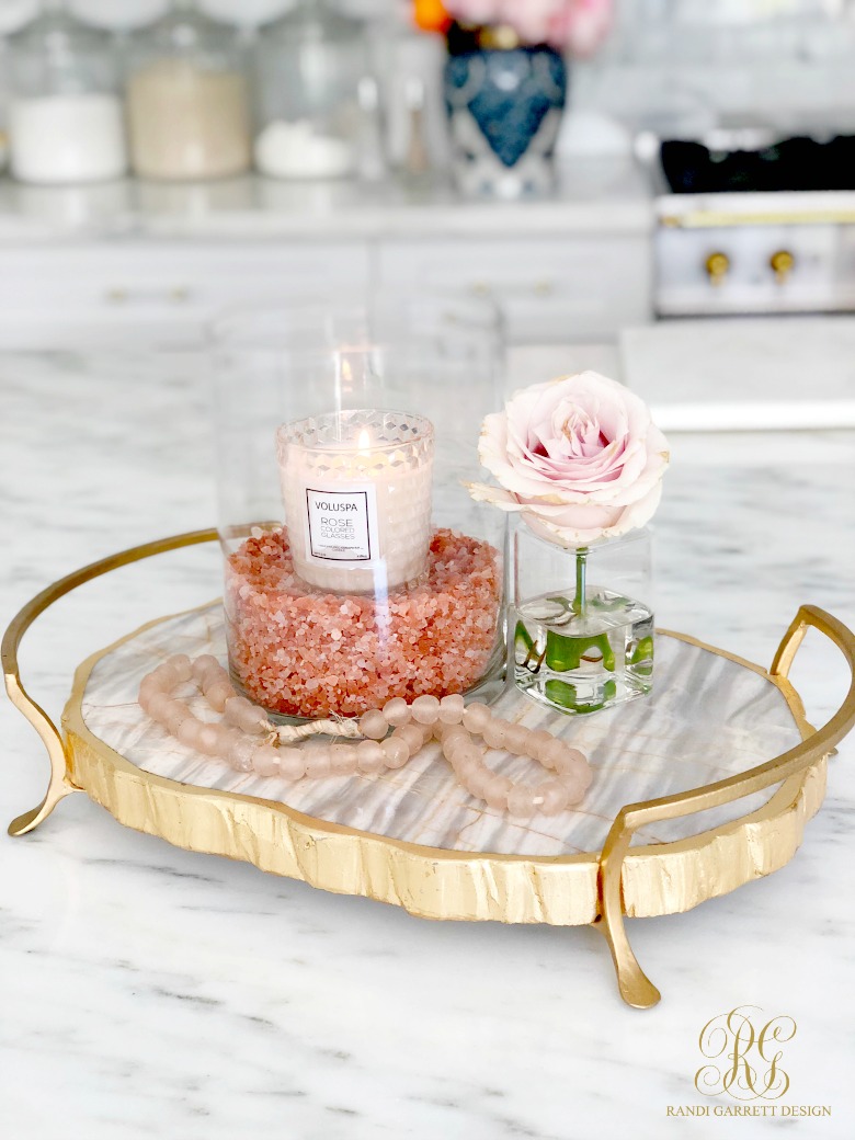 gold marble tray with pink candle in hurricane - candle styling tips