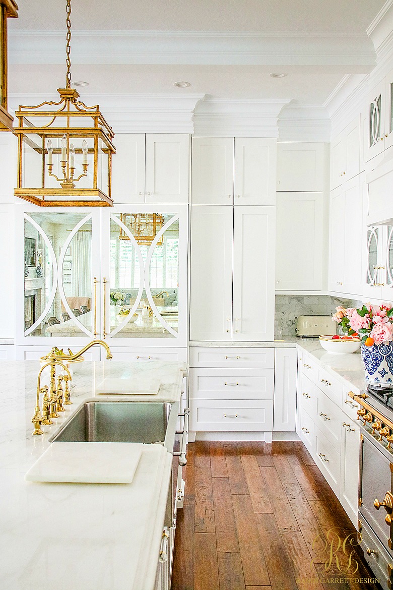 white kitchen - marble countertops - gold lighting