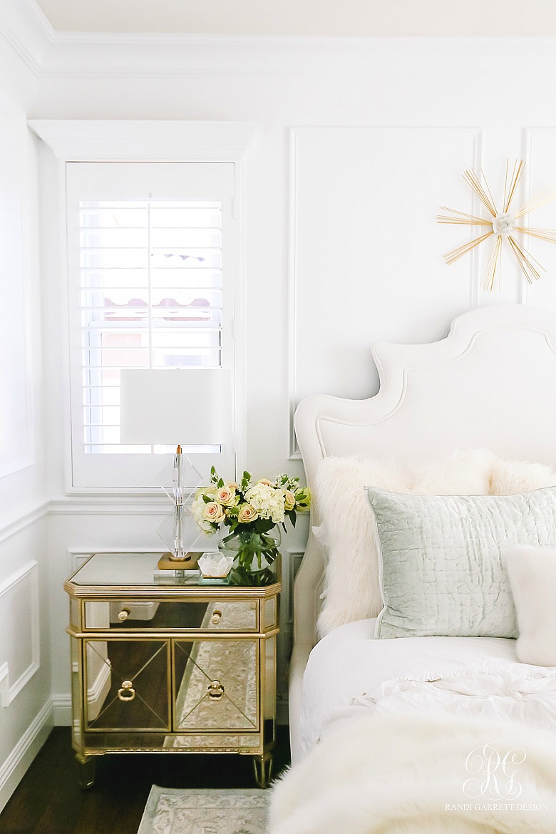 beautiful bedroom with velvet bed and glam finishings