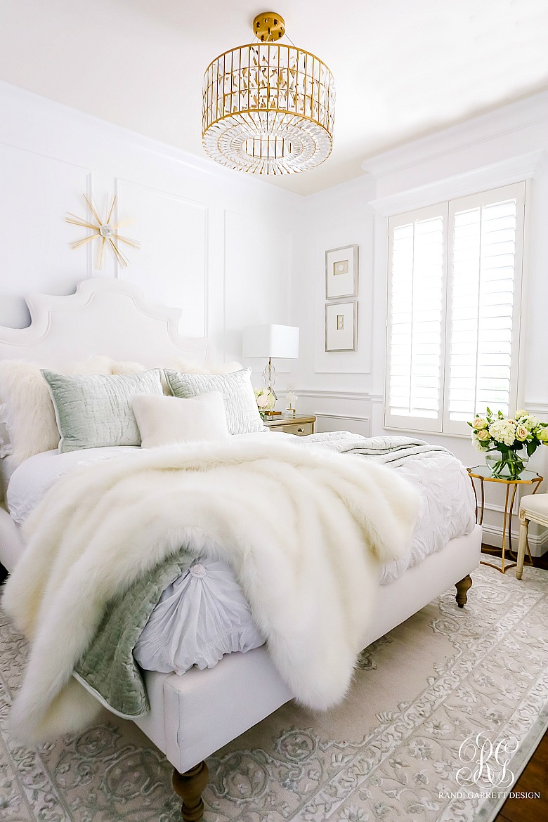 glam chandelier - luxe bedroom - white walls - wainscoting -Glam Guest Bedroom Makeover 