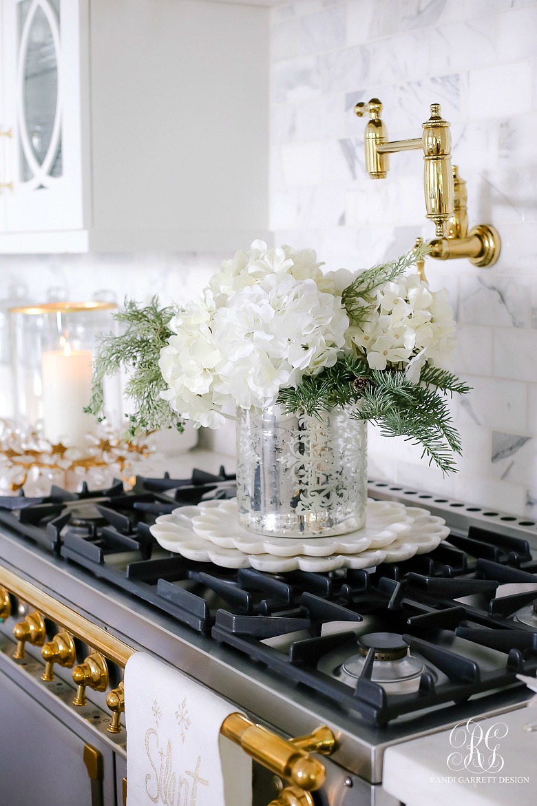 white hydrangeas pine in mercury glass vase on marble petal trays