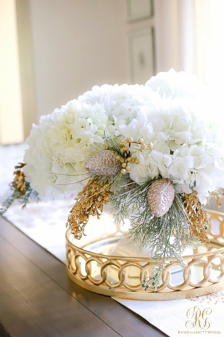 White hydrangea centerpiece with pine picks and gold berries