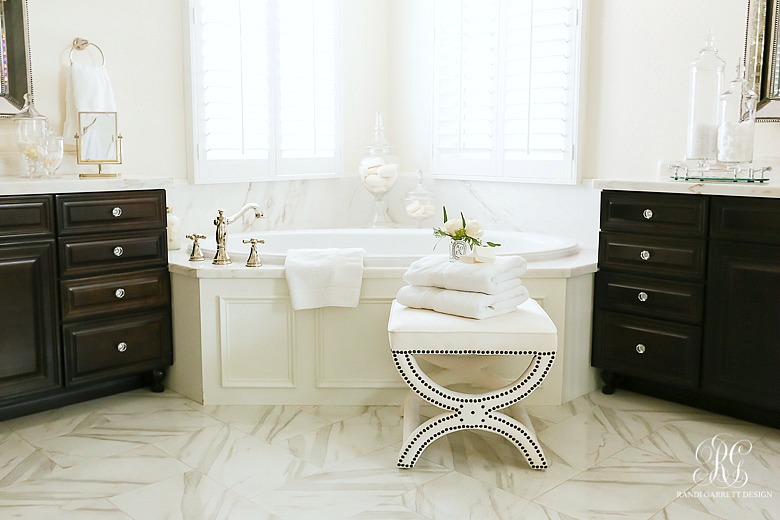 Elegant white marble master bathroom - velvet stool