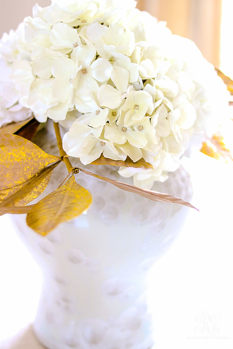 white hydrangea arrangement in white temple jar