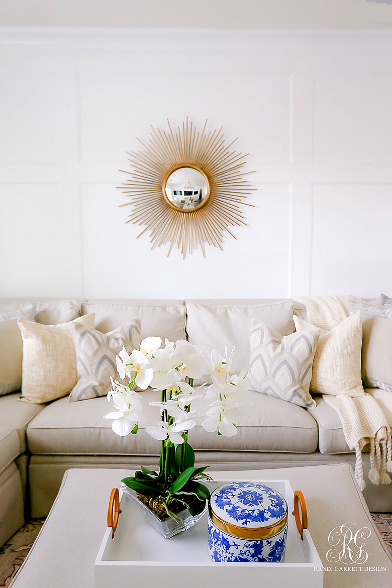 Simple Spring Decor Ideas for your Family Room - sunburst mirror - faux orchids 