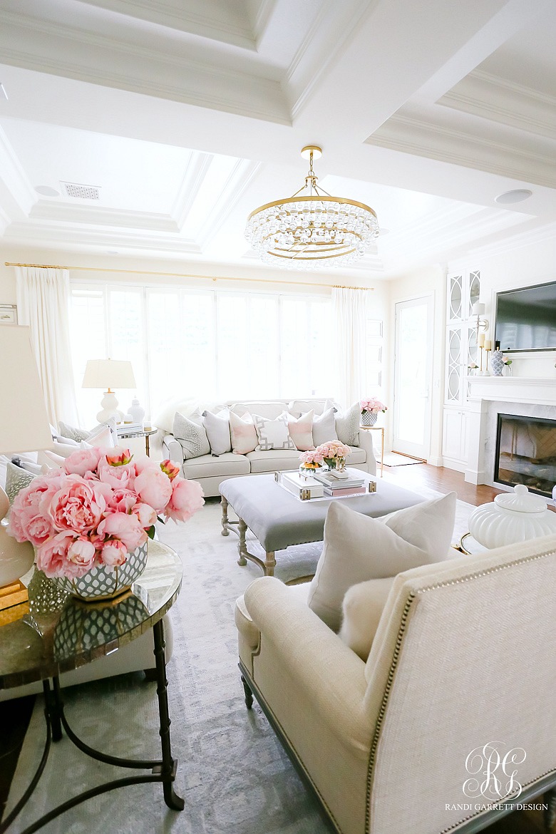 gray white family room styled for spring with pink and gold accents