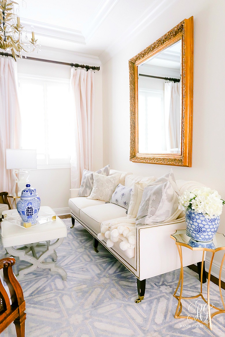 white couch with nailhead trim - ginger jars styled for spring
