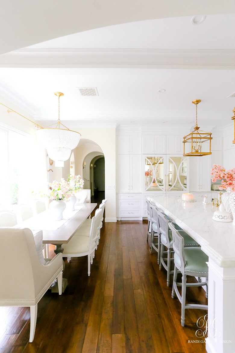 white kitchen and breakfast nook with gold lighting