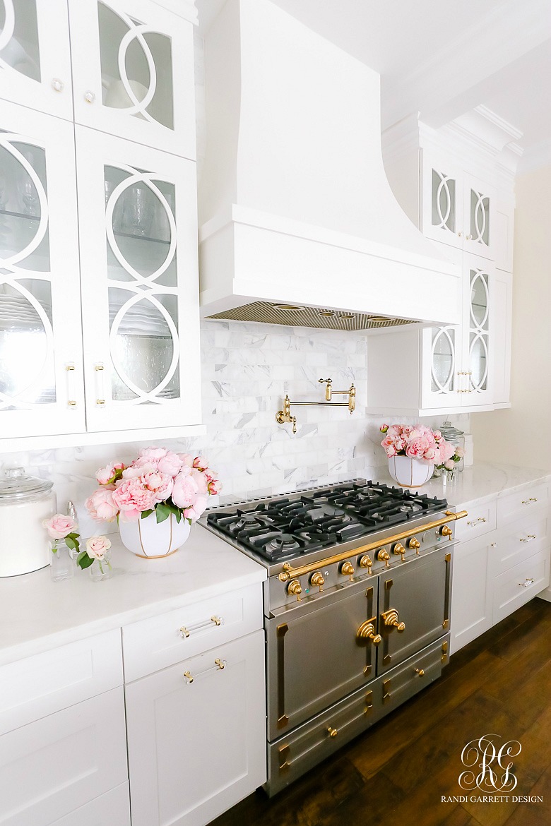 la cornue range - white kitchen cabinets - dark wood floors - marble countertops