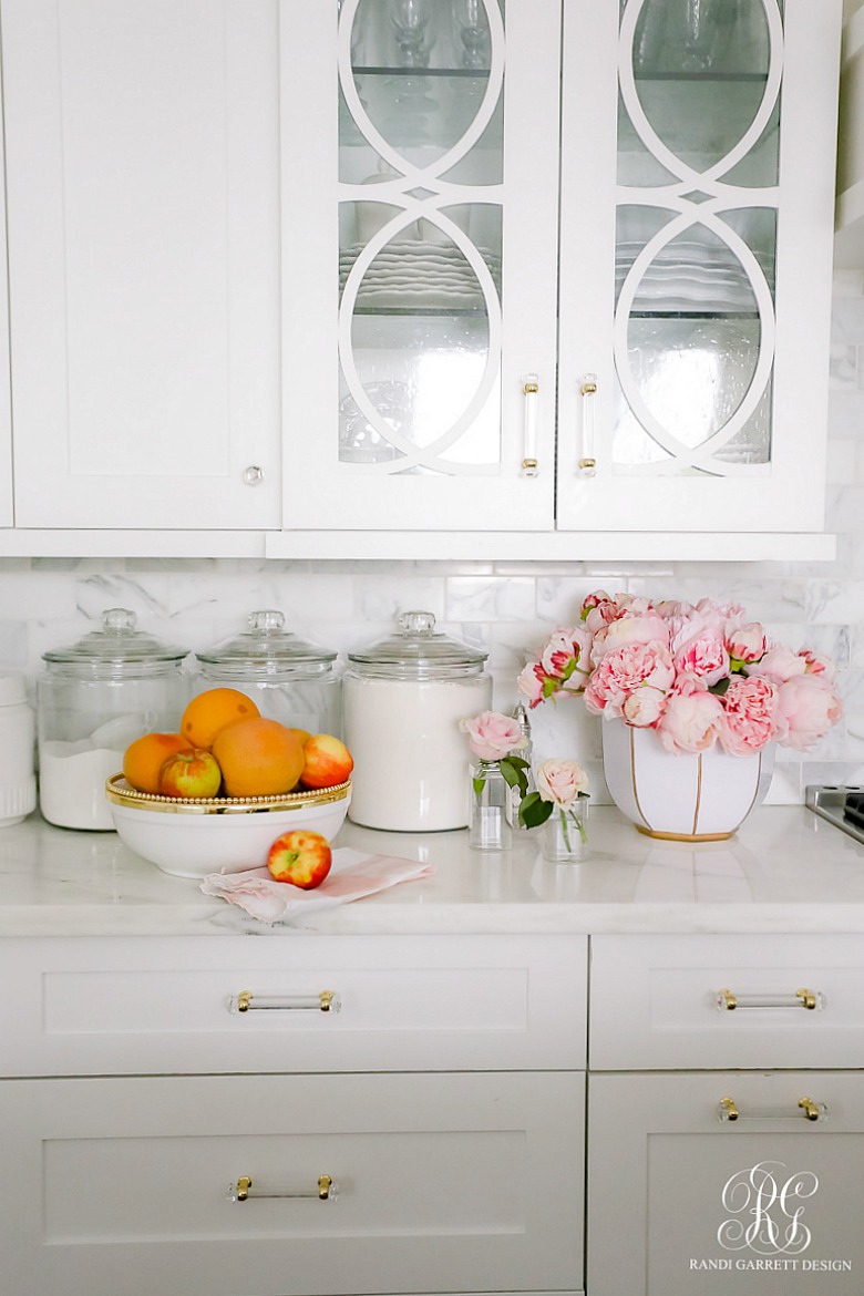 white kitchen cabinets - glass doors -decorative doors - styled for spring