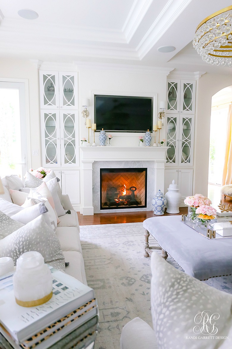 white fireplace with built in bookshelves