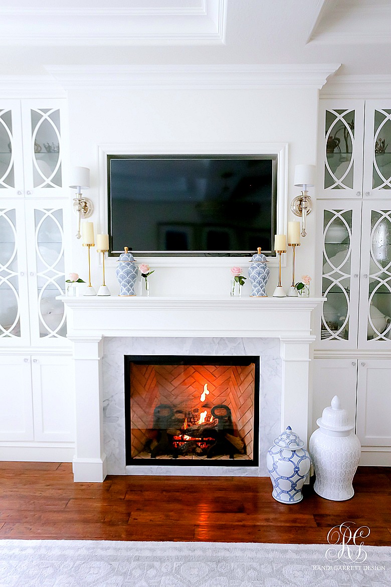 gas fireplace with builtins - decorative glass doors - styled for spring