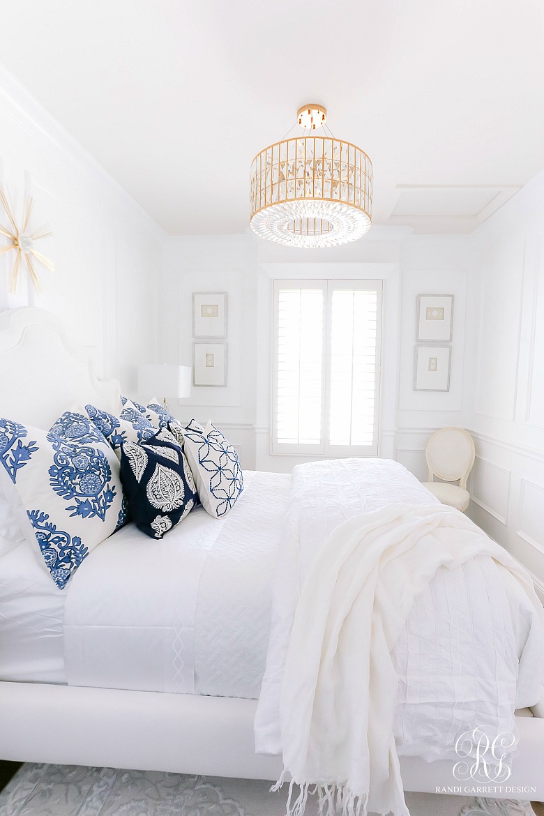 glam blue white bedroom - gold chandelier 