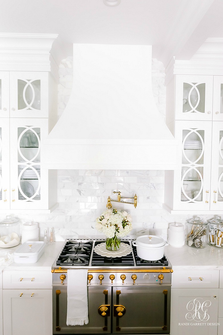 White kitchen - marble countertops - La Cornue Stove