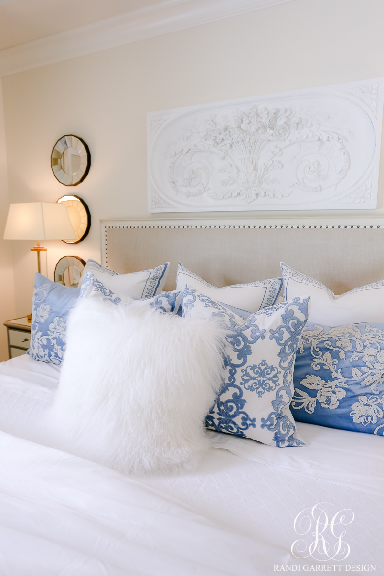 glam master bedroom blue and white pillows