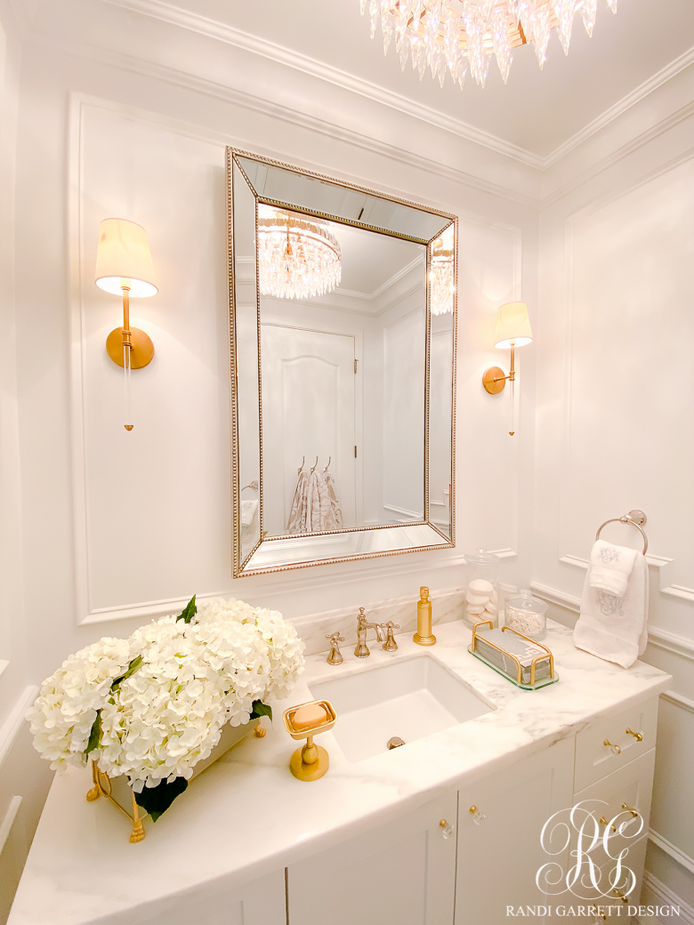 white bathroom with wainscoting gold accents