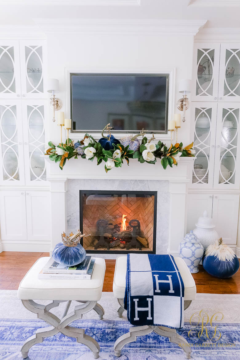 white fireplace styled for fall